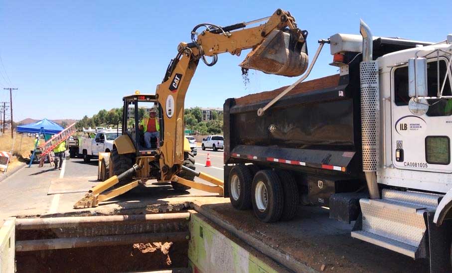 Digger dumping into truck